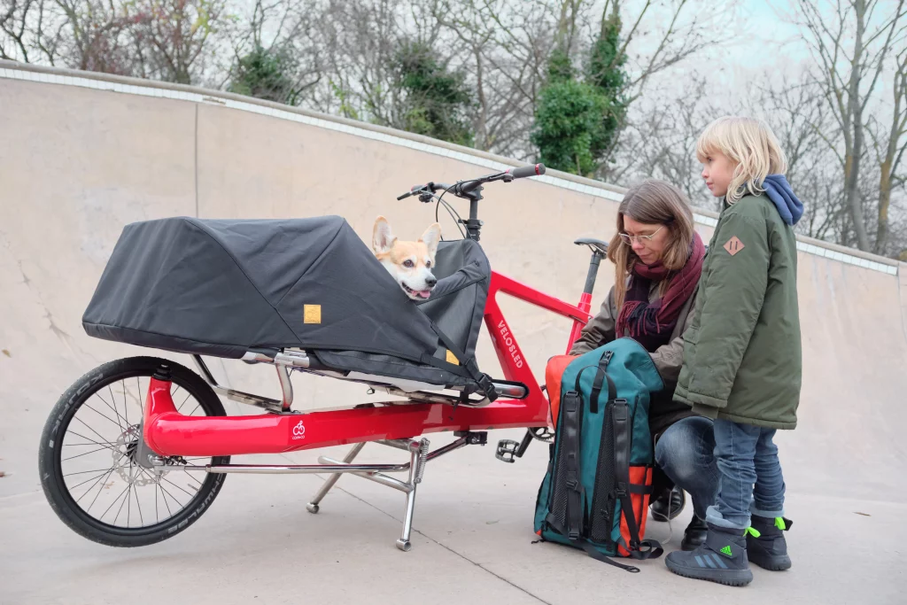 Mother with boy searches backpack in with urban cargo bike Anna is parked in Copenhagen